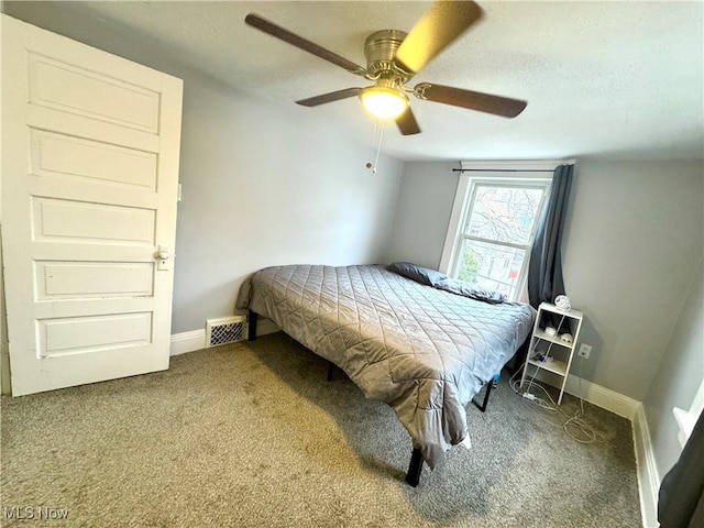 carpeted bedroom with a textured ceiling and ceiling fan