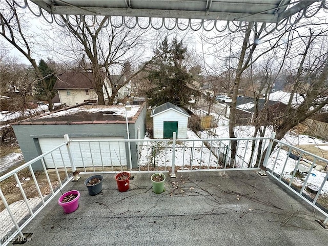 view of snow covered back of property