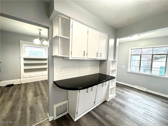 588 Robinette Ct, Akron, OH 44310 - kitchen with open shelves, dark wood finished floors, dark countertops, decorative backsplash, and a textured ceiling
