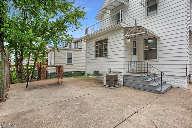 exterior space with central AC unit and a balcony