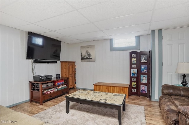 living room featuring a drop ceiling and hardwood / wood-style flooring