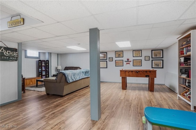 rec room featuring a drop ceiling and hardwood / wood-style flooring