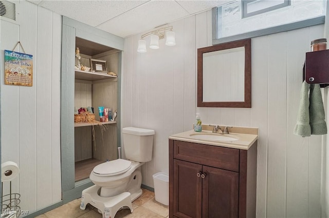 bathroom featuring tile patterned floors, vanity, and toilet