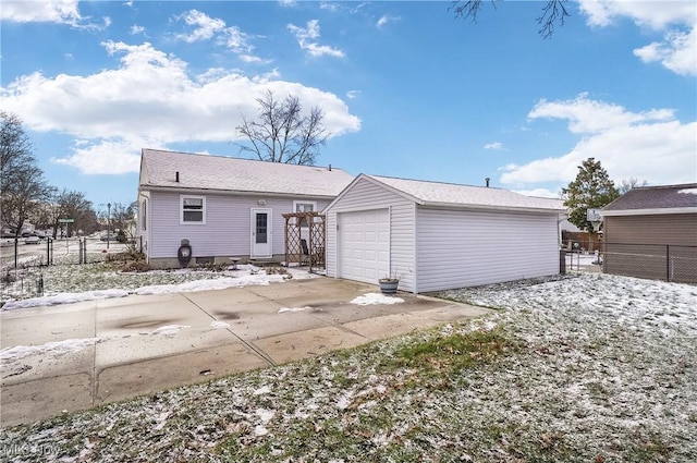 back of property with an outbuilding and a garage