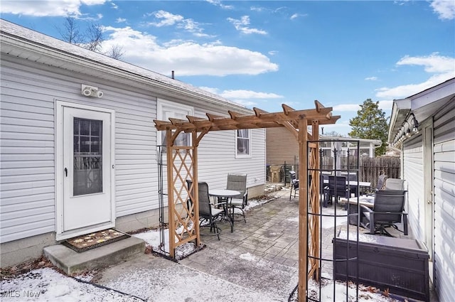 snow covered patio with a pergola