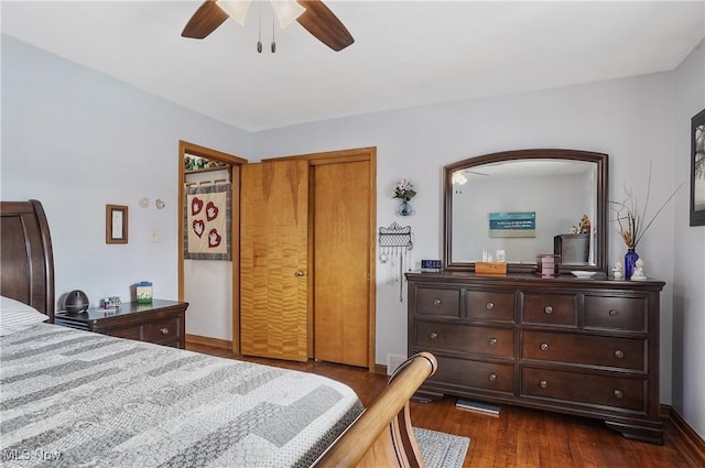 bedroom featuring dark wood-type flooring, ceiling fan, and a closet