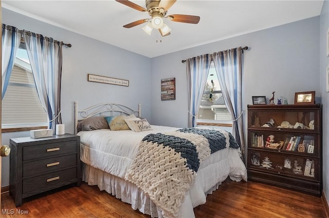 bedroom with dark wood-type flooring and ceiling fan