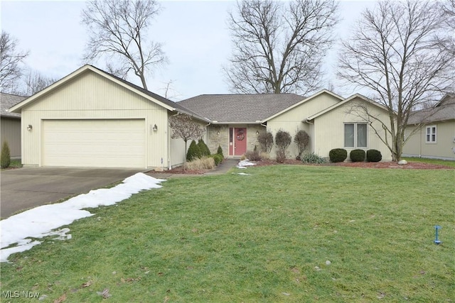 single story home featuring a garage and a front lawn