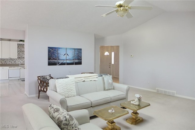 living room with lofted ceiling, light colored carpet, and ceiling fan