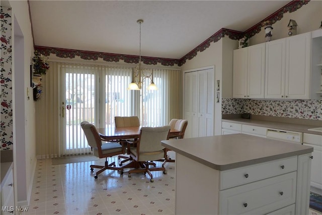 kitchen featuring pendant lighting, lofted ceiling, a center island, and white cabinets