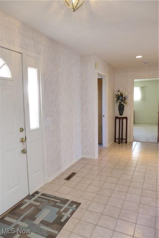 entryway with light tile patterned floors