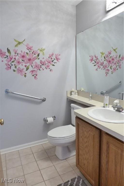 bathroom with vanity, tile patterned flooring, and toilet