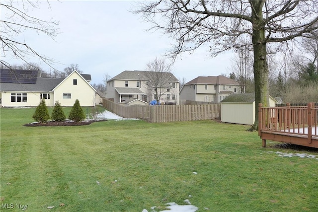 view of yard featuring a wooden deck and a shed