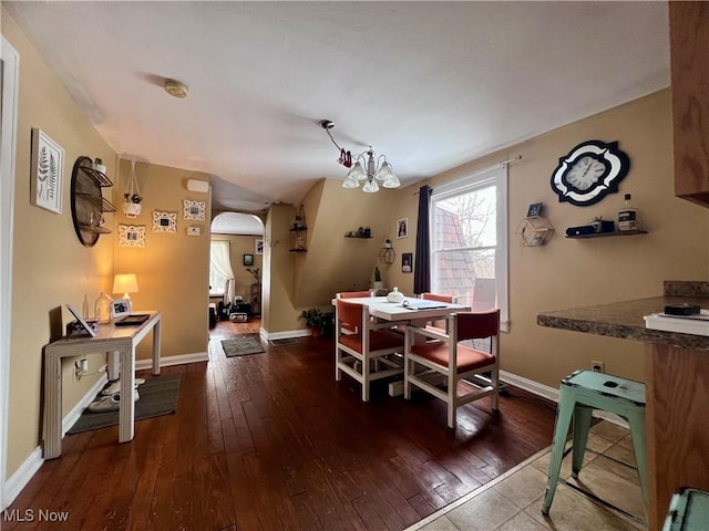 dining area featuring hardwood / wood-style flooring and a chandelier