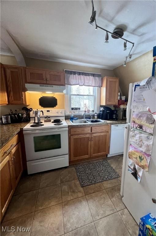 kitchen with sink, white appliances, and light tile patterned flooring