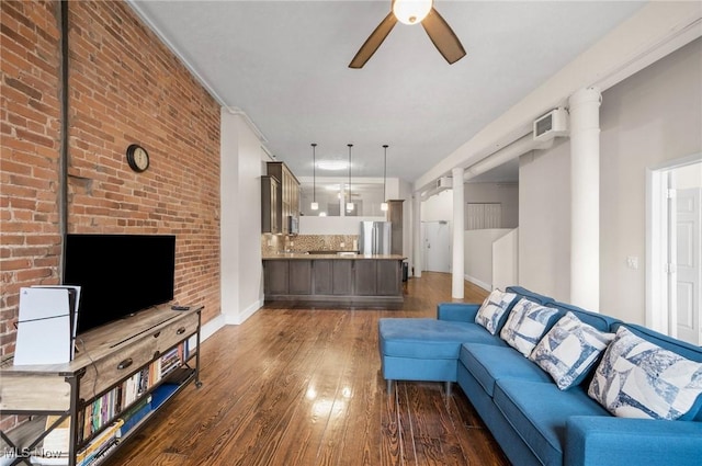 living area with baseboards, dark wood finished floors, and a ceiling fan