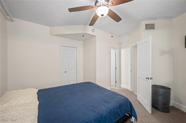 carpeted bedroom featuring baseboards, visible vents, and ceiling fan