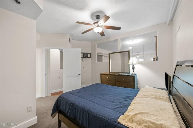 carpeted bedroom featuring visible vents, ceiling fan, a textured ceiling, and baseboards