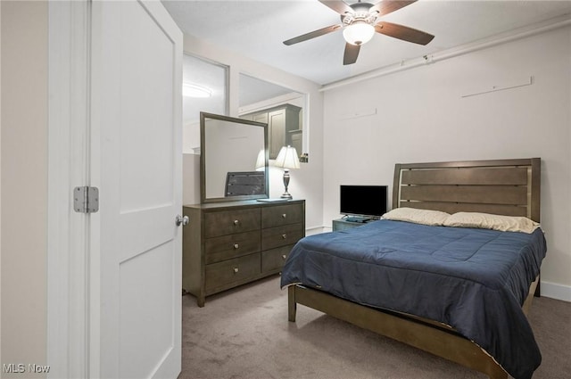 bedroom with ceiling fan and light carpet