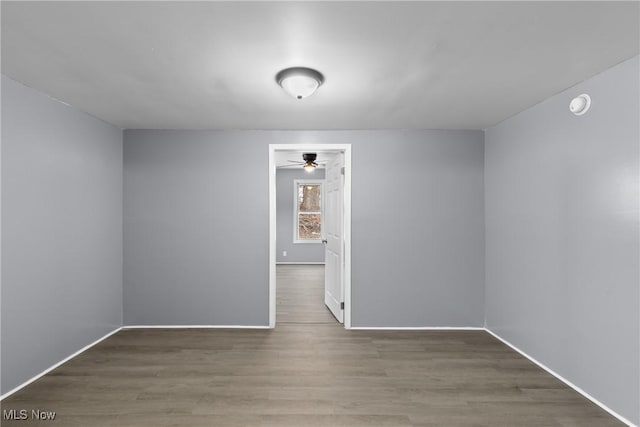 spare room featuring hardwood / wood-style floors and ceiling fan