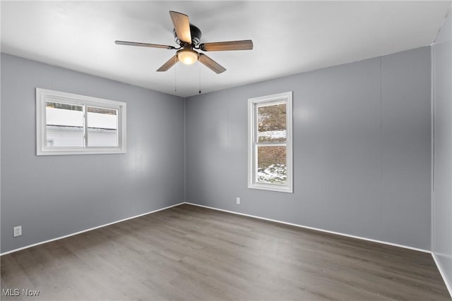 empty room featuring ceiling fan and dark hardwood / wood-style floors