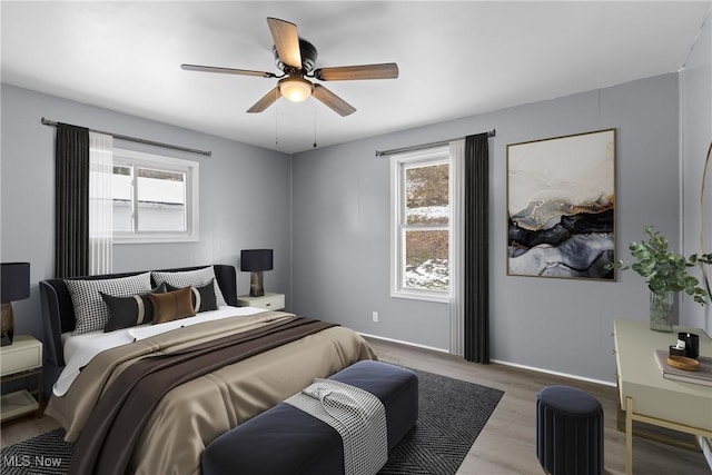 bedroom with ceiling fan and light hardwood / wood-style flooring