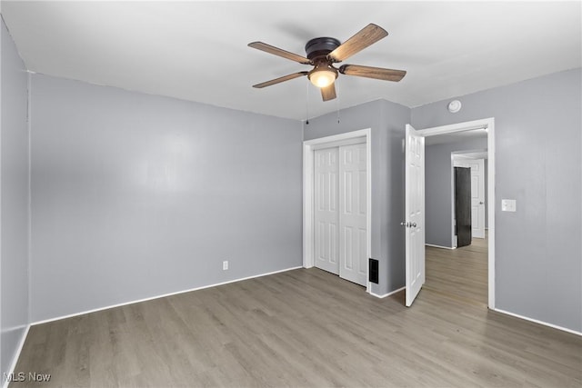 unfurnished bedroom with a closet, ceiling fan, and light wood-type flooring