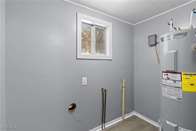 laundry room featuring ornamental molding and electric water heater