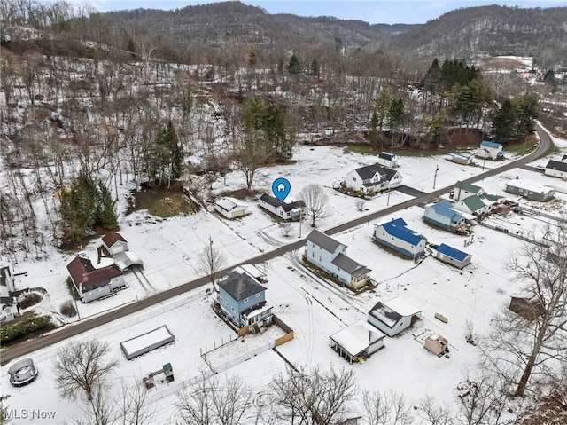 snowy aerial view with a mountain view