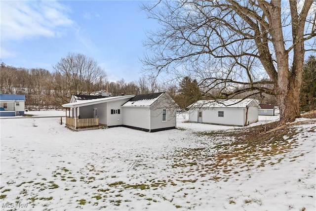 view of snow covered rear of property