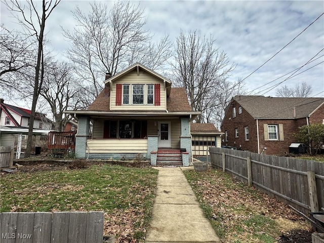 bungalow-style house featuring a garage and covered porch