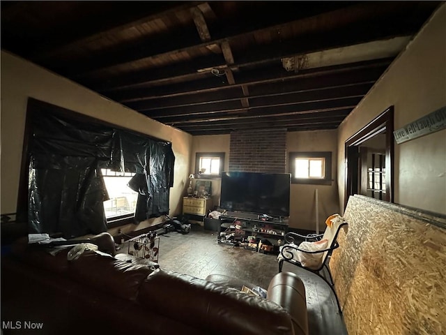 living room featuring beamed ceiling and wood-type flooring