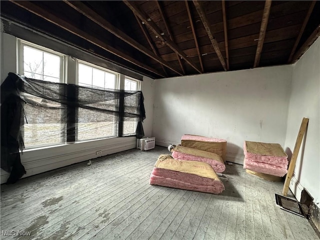 sitting room featuring hardwood / wood-style flooring and lofted ceiling with beams