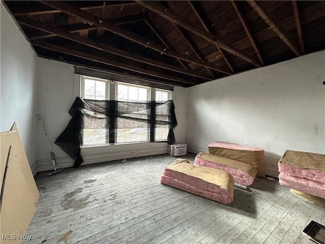 interior space featuring lofted ceiling and light hardwood / wood-style flooring