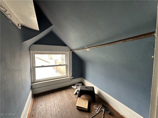 bonus room with vaulted ceiling and wood-type flooring