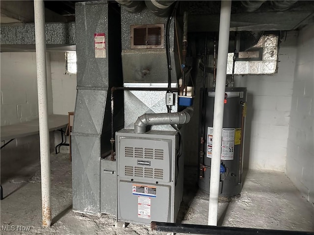 utility room with heating unit and water heater