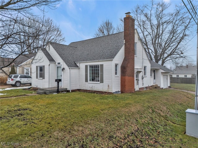 view of front of home with a garage and a front lawn