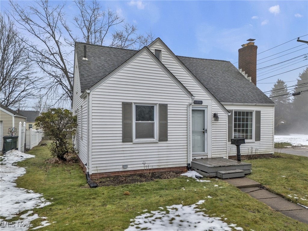 bungalow-style home featuring a front yard