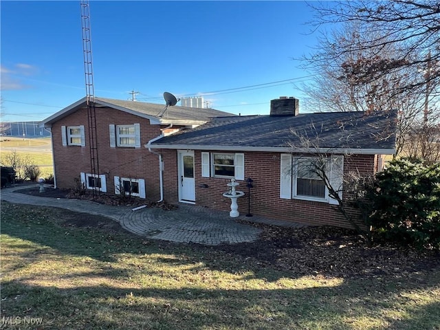 back of house featuring a patio and a yard