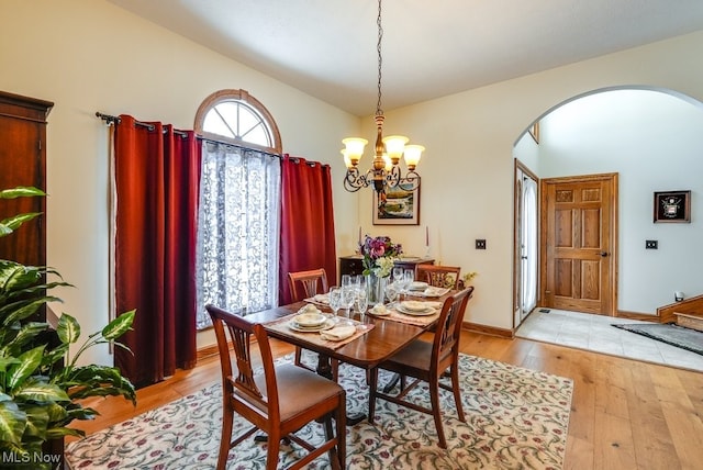 dining room with a chandelier and light hardwood / wood-style flooring