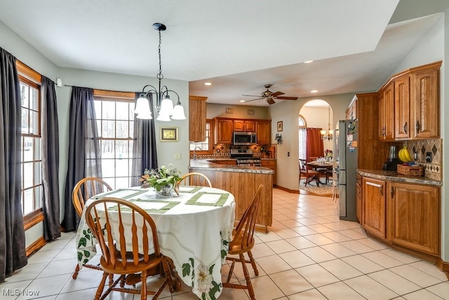 dining space with an inviting chandelier and light tile patterned floors