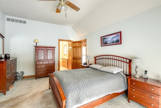 carpeted bedroom with ceiling fan, connected bathroom, and vaulted ceiling