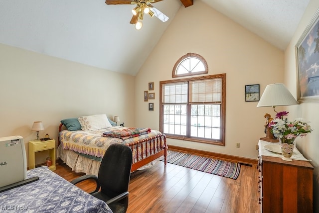 bedroom with hardwood / wood-style flooring, ceiling fan, and high vaulted ceiling