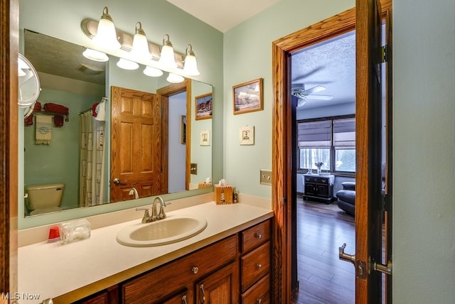 bathroom featuring hardwood / wood-style flooring, vanity, and toilet