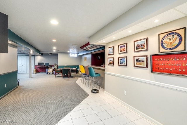 playroom with built in desk and light carpet