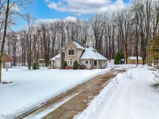 view of front of house featuring a storage shed