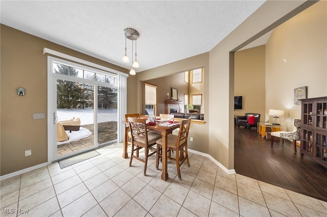 dining area with light tile patterned flooring and a textured ceiling