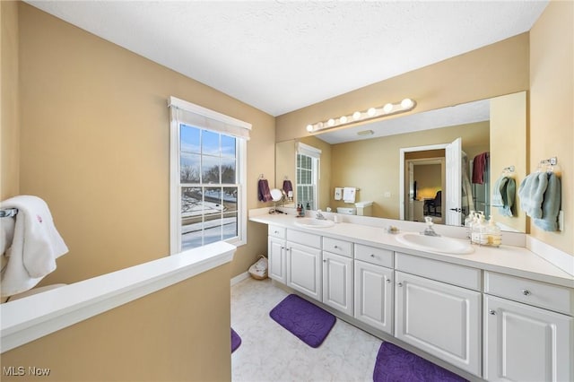 bathroom featuring vanity and a textured ceiling