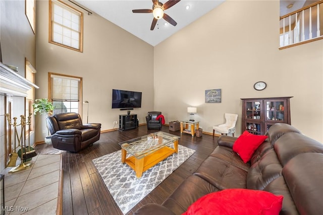 living room with ceiling fan, wood-type flooring, and high vaulted ceiling