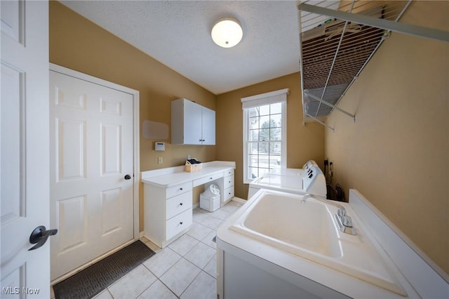 bathroom featuring tile patterned flooring, vanity, a textured ceiling, and washing machine and clothes dryer